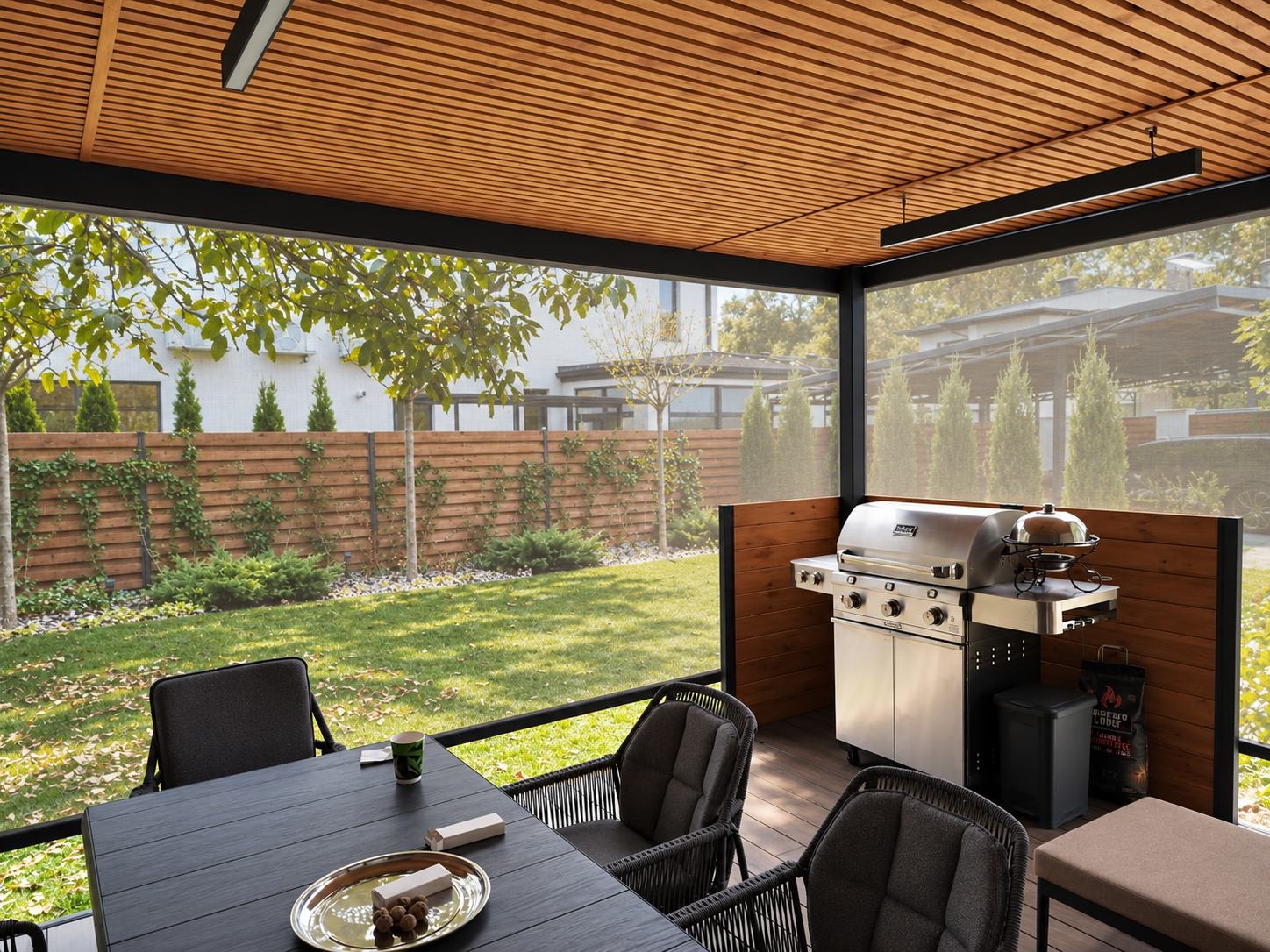 Zona de comedor bajo una pérgola con techo de madera